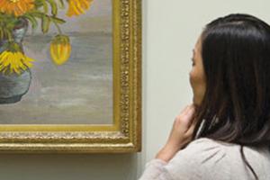 woman looking at art in museum