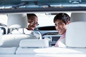 Multi-ethnic teenage boys (17 and 19 years) driving car.