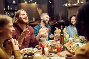 friends eating dinner at holiday party