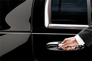 Limousine driver opening the car door