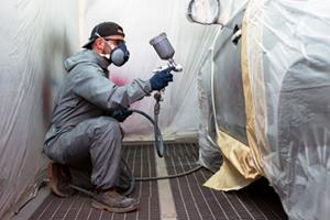 man working in a spray booth