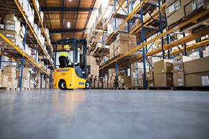 forklift driver in warehouse moving boxes