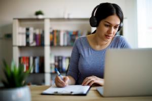 woman wearing headphones working at home