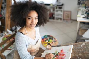 artist_iS1159909834.jpg Artist smiling while working on a painting