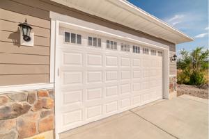 A white garage door in a suburban home