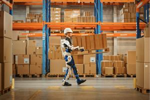 Warehouse worker wearing exoskeleton technology carrying a pallet of boxes