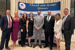 Business professionals pose at a Folds of Honor fundraising event